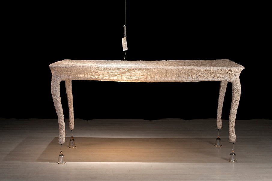 Catalina Mena
Want/Love, 2012
Table made from cotton thread, four crystal glasses, and a perforated kitchen cleaver hand-embroidered with golden thread, 190 x 96 x 96 cm