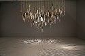 Catalina Mena, Domestic Lexicon
2012, different kinds of used kitchen knives hand-embroidered with gold thread suspended from the ceiling by the  same gold thread and metal nails