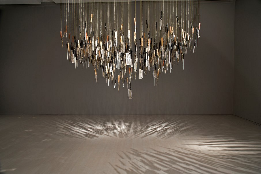 Catalina Mena
Domestic Lexicon, 2012
different kinds of used kitchen knives hand-embroidered with gold thread suspended from the ceiling by the  same gold thread and metal nails, 200 x 200 x 480 cm